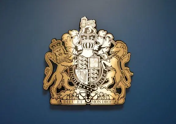 Royal Coat of arms on a blue feature wall at the Coroner's Court.