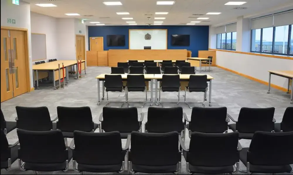 Image of the main court at Beacon House, Ipswich. A room set out with chairs and tables in a court room setting.